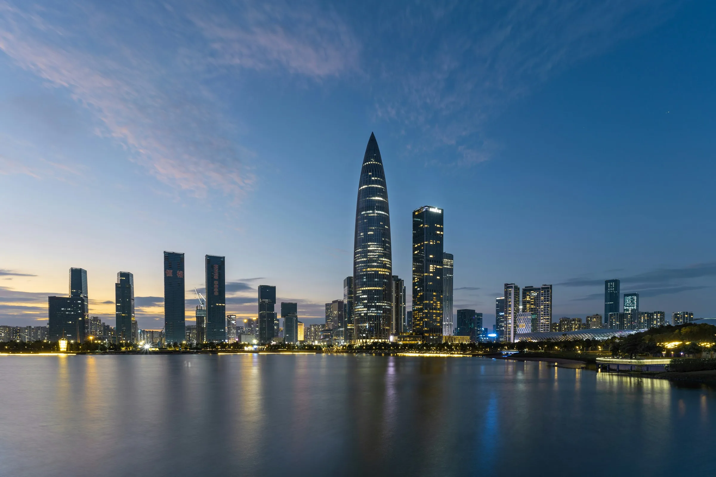 Shenzhen skyline at dusk, looking across Houhai toward the city centre — the Modern China urban tempo.
